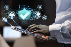 Business professional using a tablet with floating digital icons representing cloud storage, data protection, user access, and backup management.